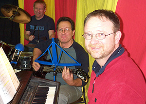 Musicians Martin Cox (keyboard), John Plunkett (strums), and Gareth Dean (drums).